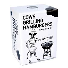 Cows Grilling Hamburger board game setup featuring cow player pieces, burger patties, ingredients, order cards, and colorful barnyard-themed components.